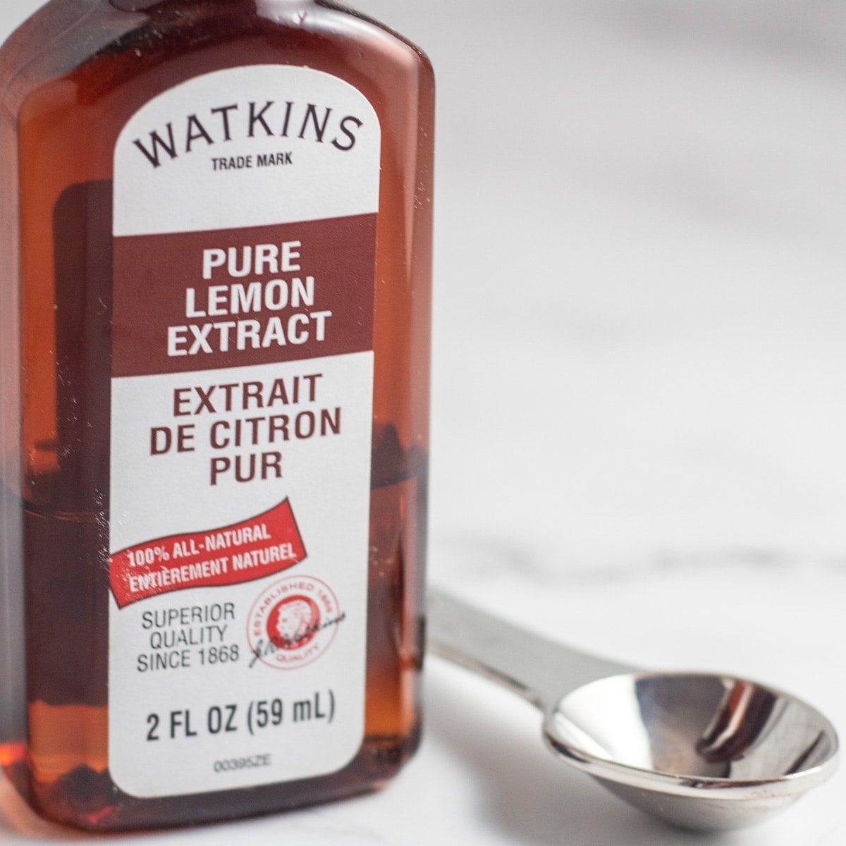 Lemon extract substitute image with bottled lemon extract.