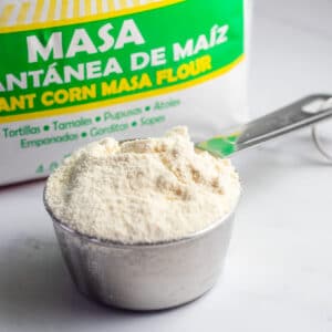 Masa harina substitute image with measuring cup of masa harina.