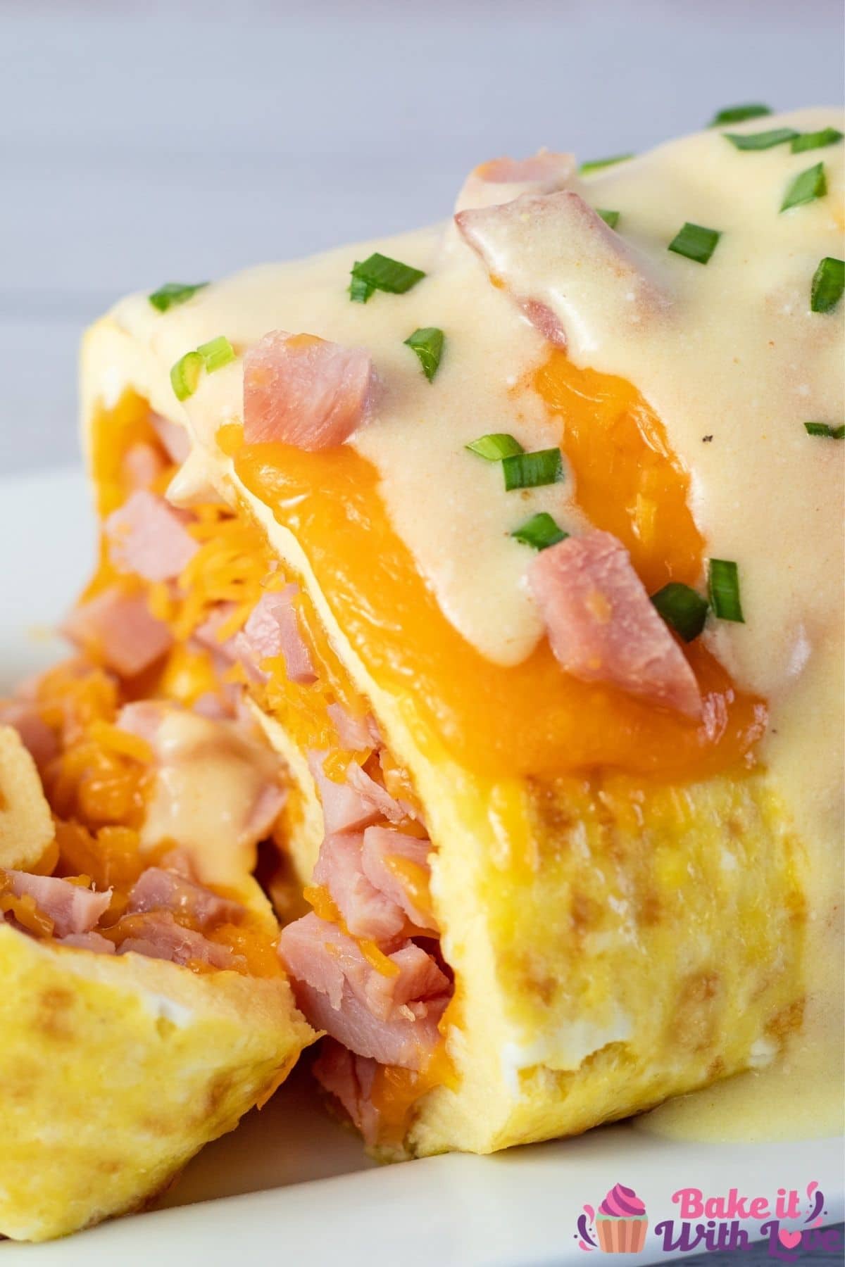 Closeup on the sliced omelet roll filled with ham and cheese.