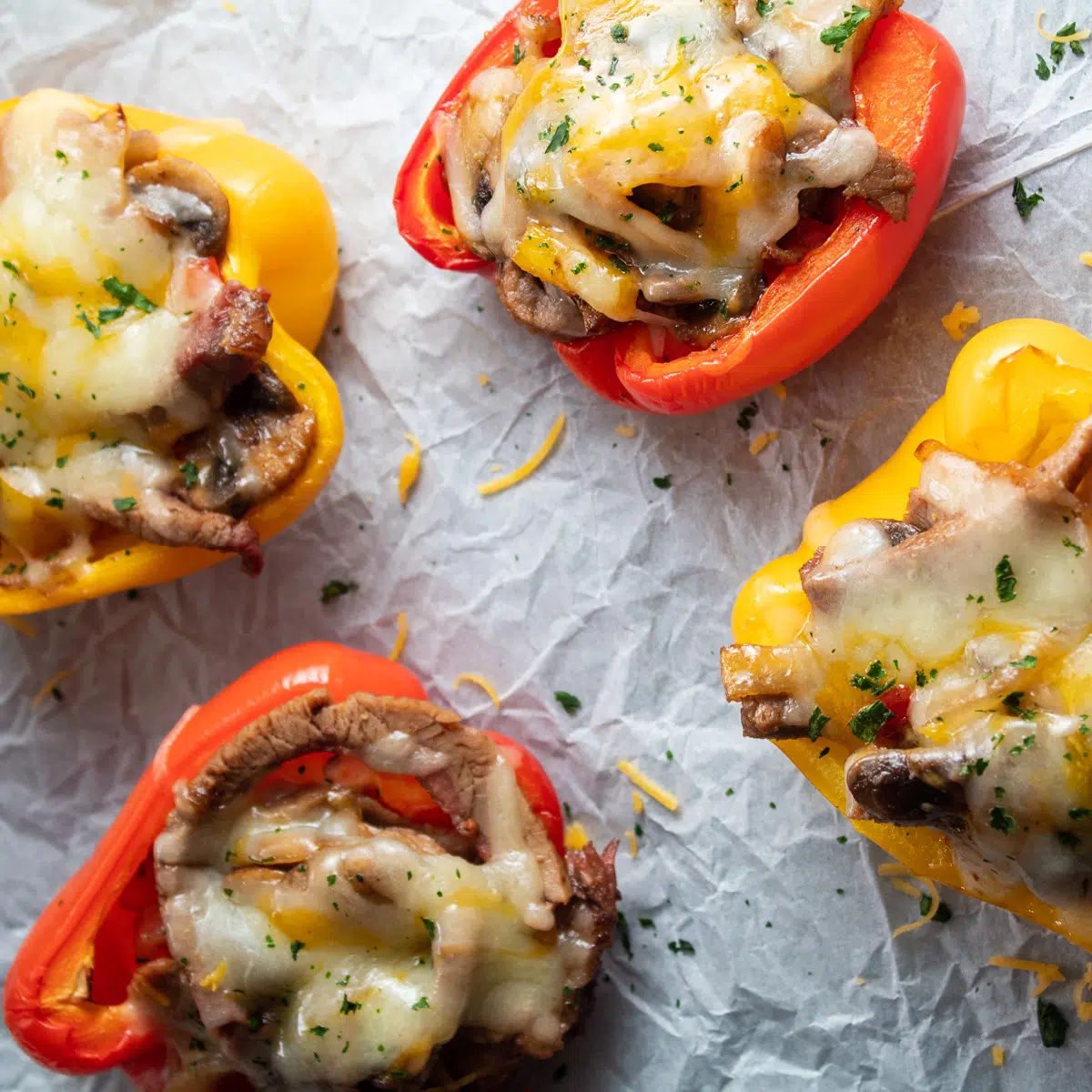 Overhead image of stuffed peppers on parchment paper.
