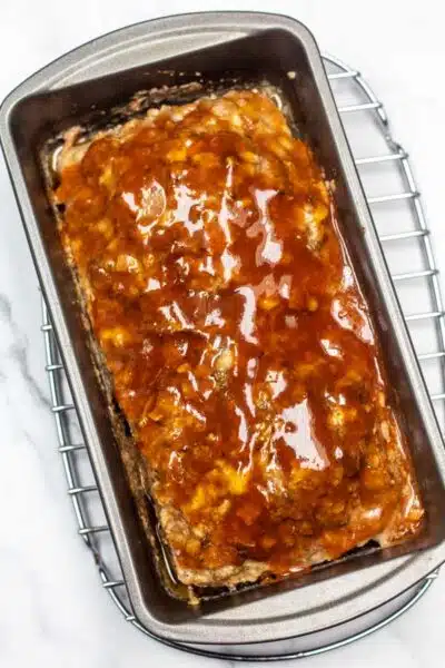 Meatloaf out of the oven with additional topping.