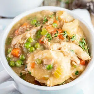 Hearty Bisquick chicken and dumplings served in white soup bowl.
