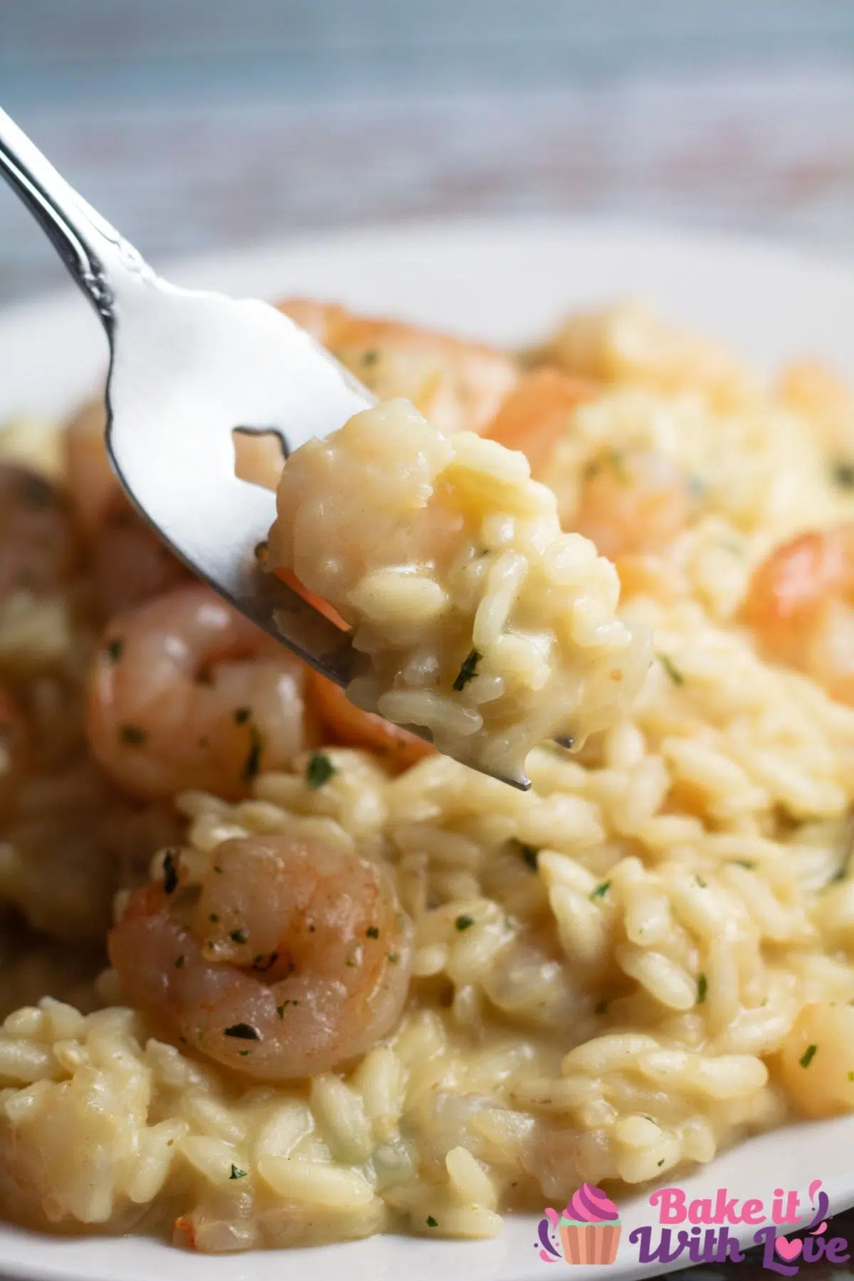 Tall image of prawn risotto on a white plate.