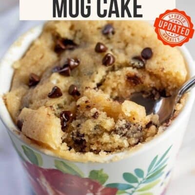 Chocolate chip mug cake Pinterest pin with an up-close image of a single-serving chocolate chip cake in a mug with text overlayed and a red stamp that reads 'updated'.