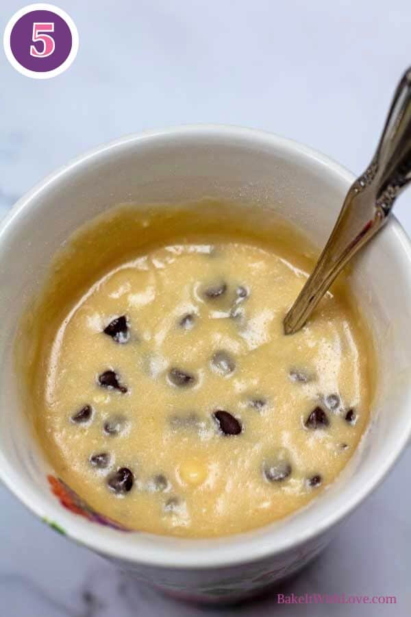 Chocolate chip mug cake process photo 5 showing the finished cake batter with added chocolate chips in a coffee mug.