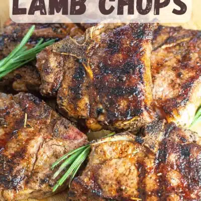 Pin image with text of grilled lamb chops on a wooden cutting board.
