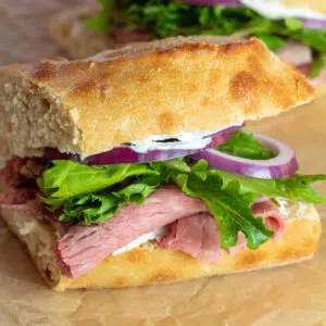 Square image of prime rib sandwich.