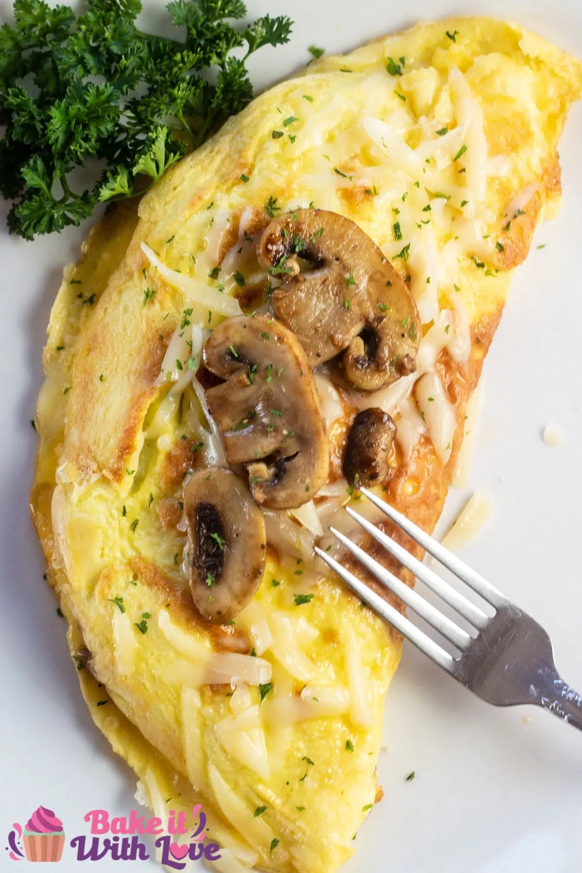 Tall image of mushroom swiss omelet on a white plate.