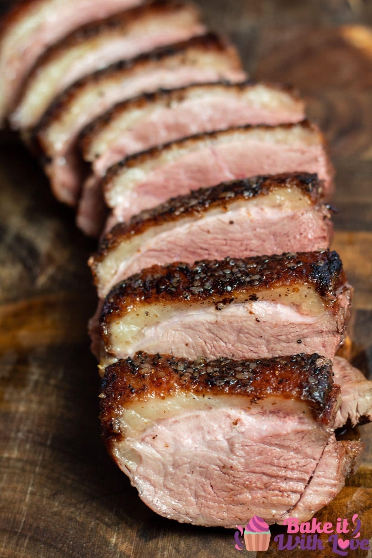 Tall image of the sliced and served pan seared duck breast with crispy skin.