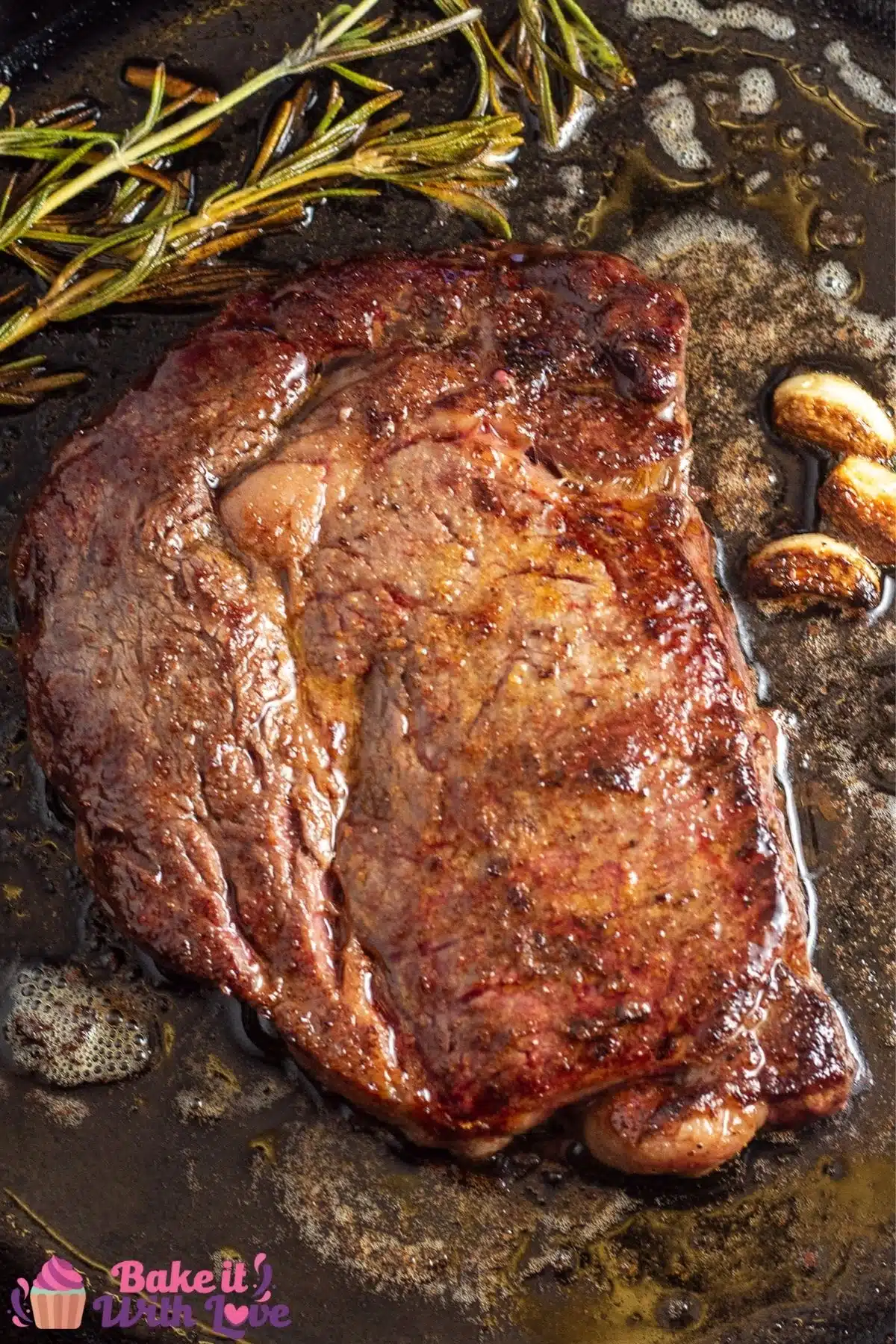 Tall photo of wagyu steak in pan.