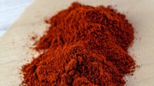 Wide image of paprika on parchment paper.