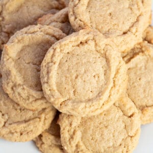 Square overhead image of multiple peanut butter cookies.