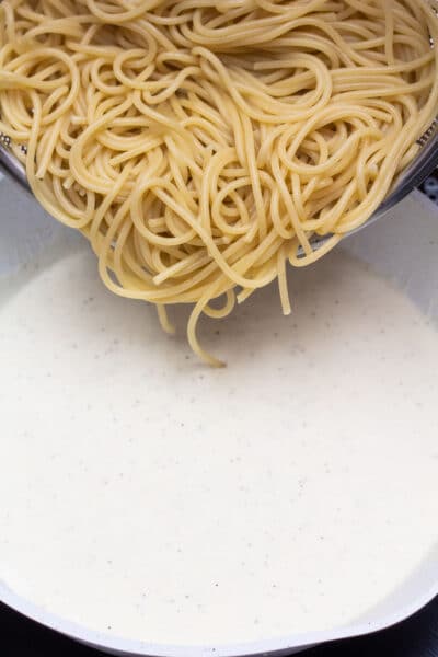 Process photo 5 add cooked spaghetti pasta to the cream cheese sauce.