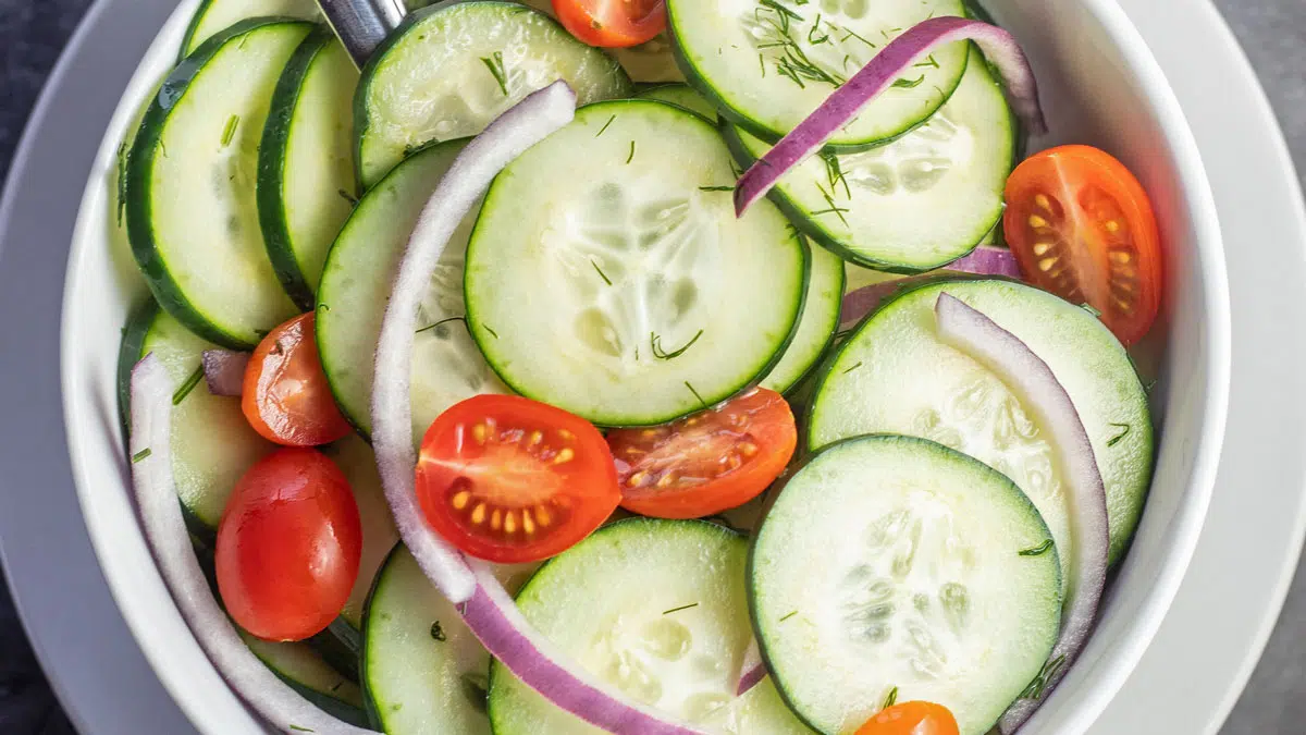 Overhead clloseup of the best cucumber vinegar salad tossed in a tangy vinegar dill marinade.