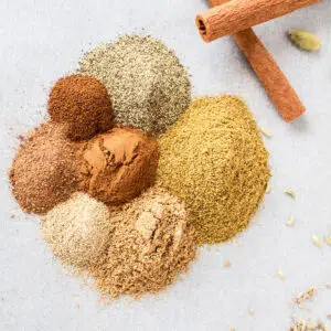 Square image of garam masala spices on a white background.