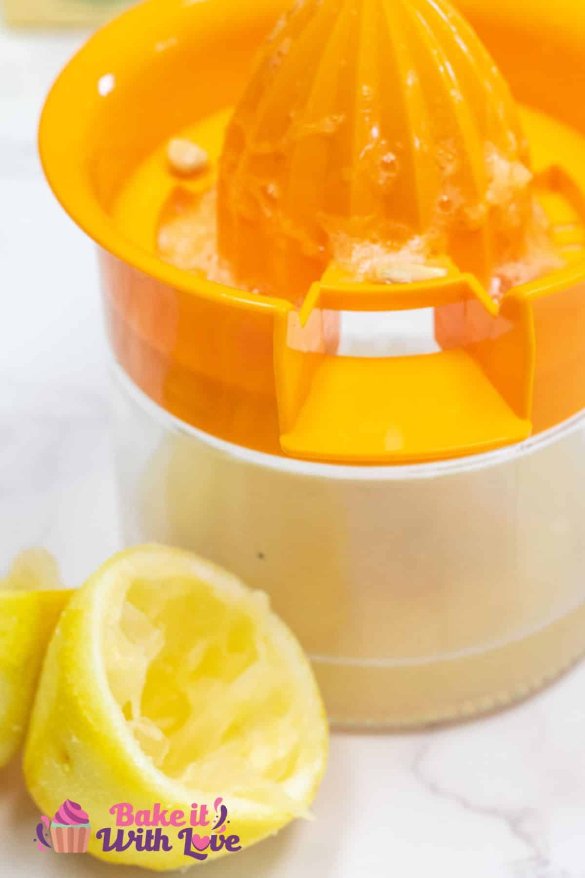 Tall image of a glass juicer jar with lemon rinds after juicing them by the bottom of the jar.