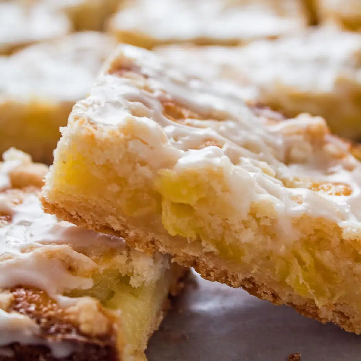 Square close up image of pineapple bars.