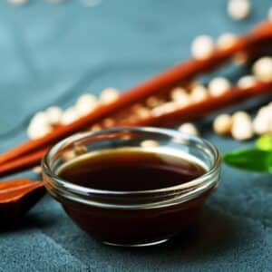 Best soy sauce substitute image of soy sauce in glass bowl.