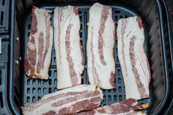 Process photo 1 bacon strips cut in half and placed in a single layer in air fryer basket.