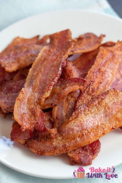 Best air fryer bacon stacked on plate and served.