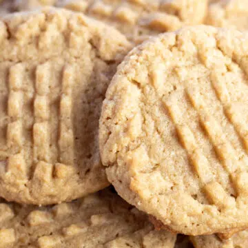 Wide image of almond flour peanut butter cookies on a white plate.