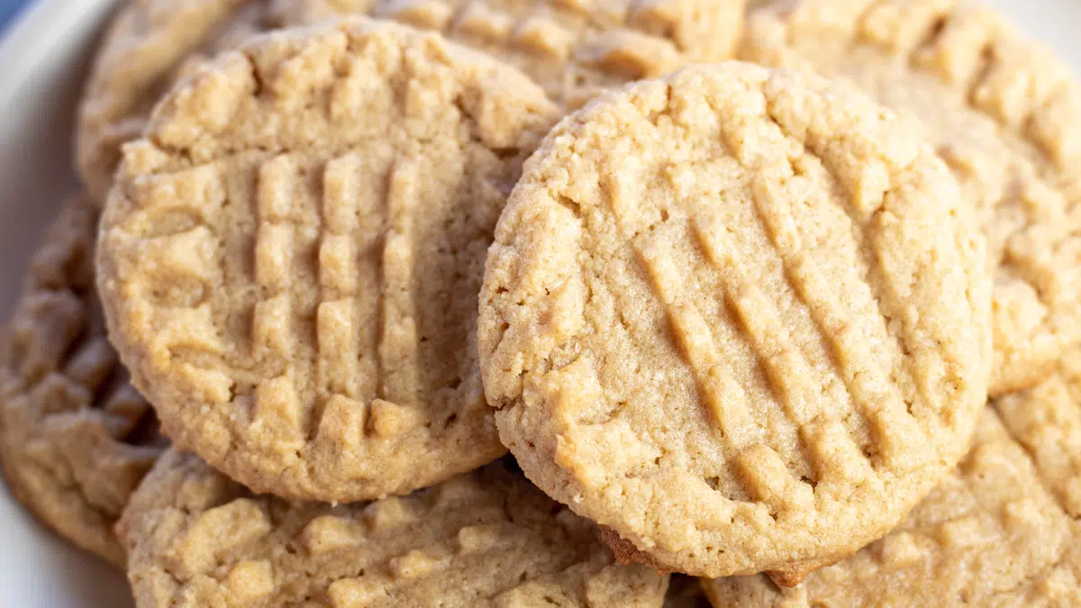 Wide image of almond flour peanut butter cookies on a white plate.
