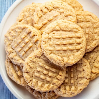 Square image of almond flour peanut butter cookies on a white plate.