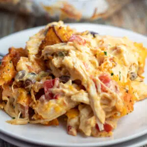 Best nacho cheese chicken Doritos casserole served on white plate.