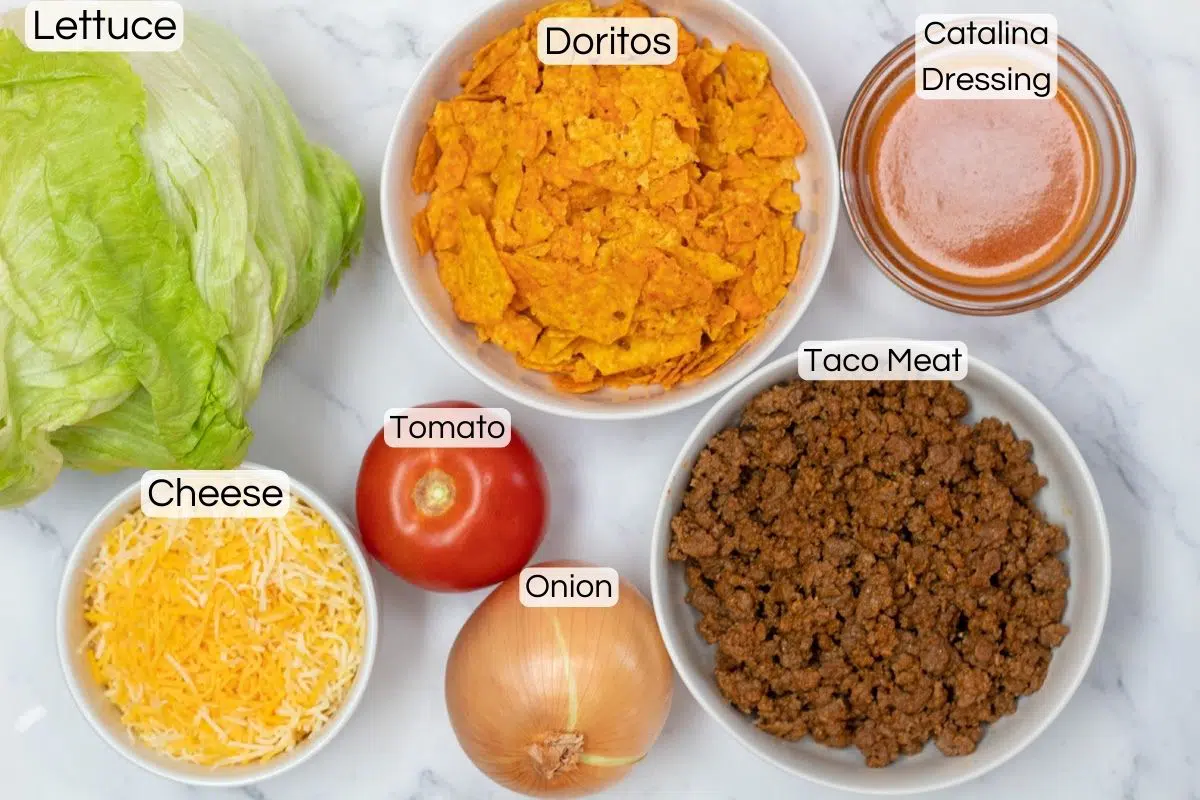 Wide image showing labeled ingredients needed for Doritos taco salad.