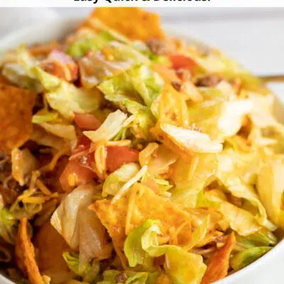 Pin image with text of Doritos taco salad in a white bowl.