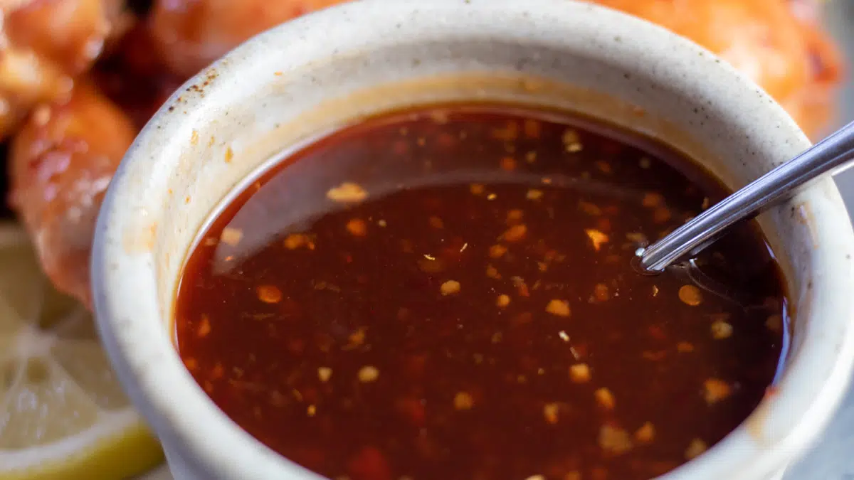 Wide image of Hawaiian bbq sauce in a small bowl with a spoon.