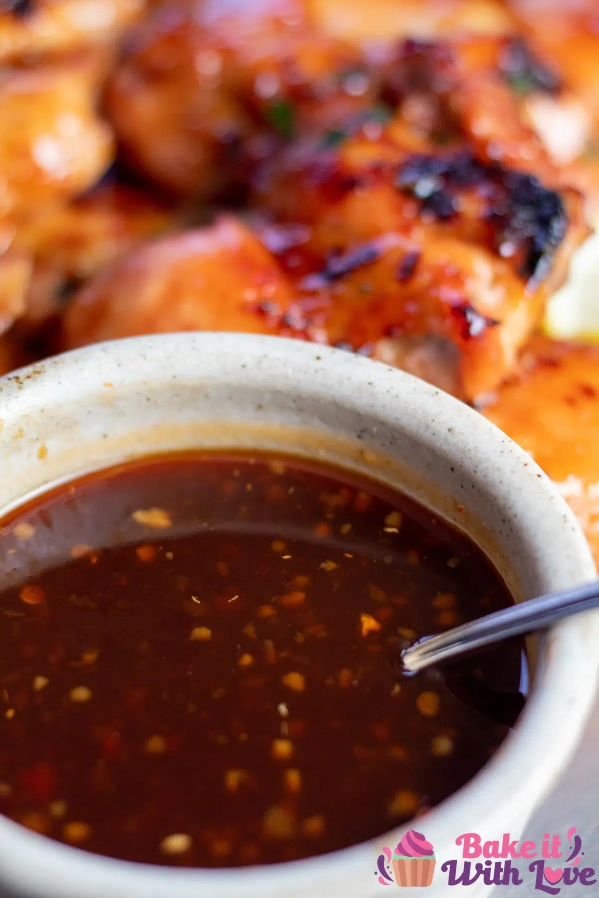 Tall image of Hawaiian bbq sauce in a small bowl with a spoon.