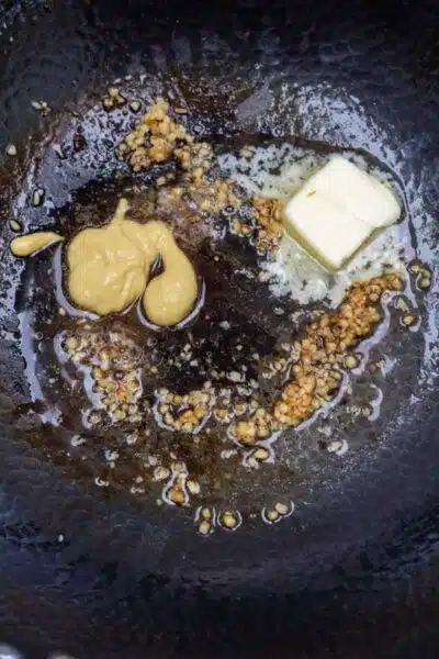 Process photo 2 melt butter, saute garlic, and mix with Dijon mustard.