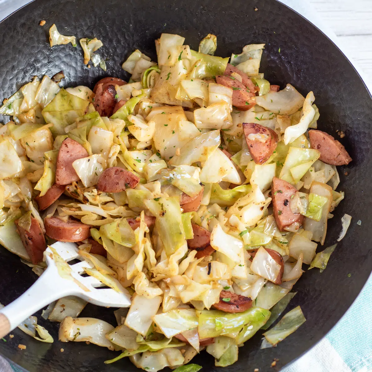 Square image of the kielbasa cabbage skillet meal ready to serve.
