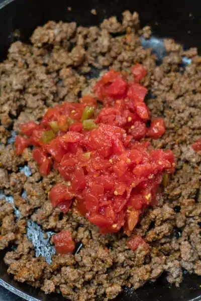 Process photo 3 add the canned Rotel tomatoes to taco seasoned browned ground beef.