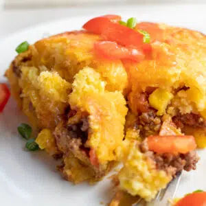 Mexican cornbread casserole closeup image of the cut square.