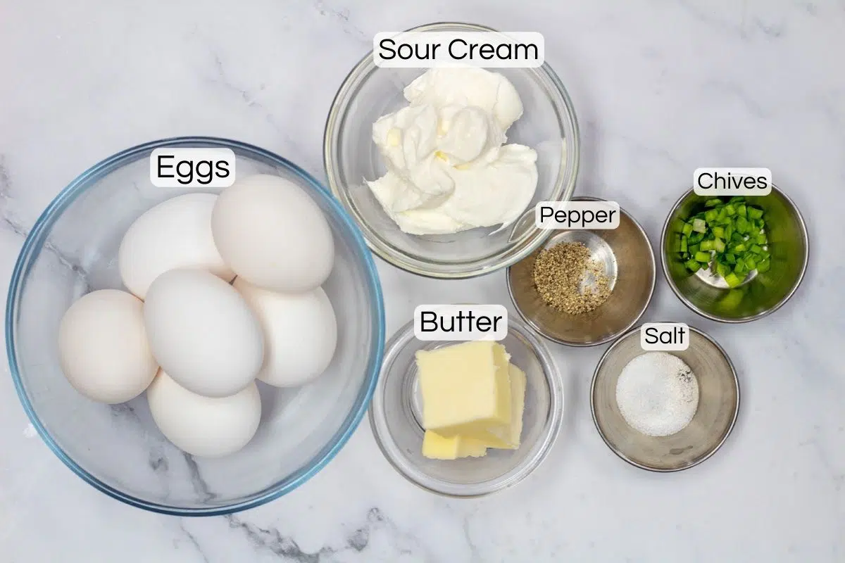 Wide image showing ingredients needed for sour cream scrambled eggs.