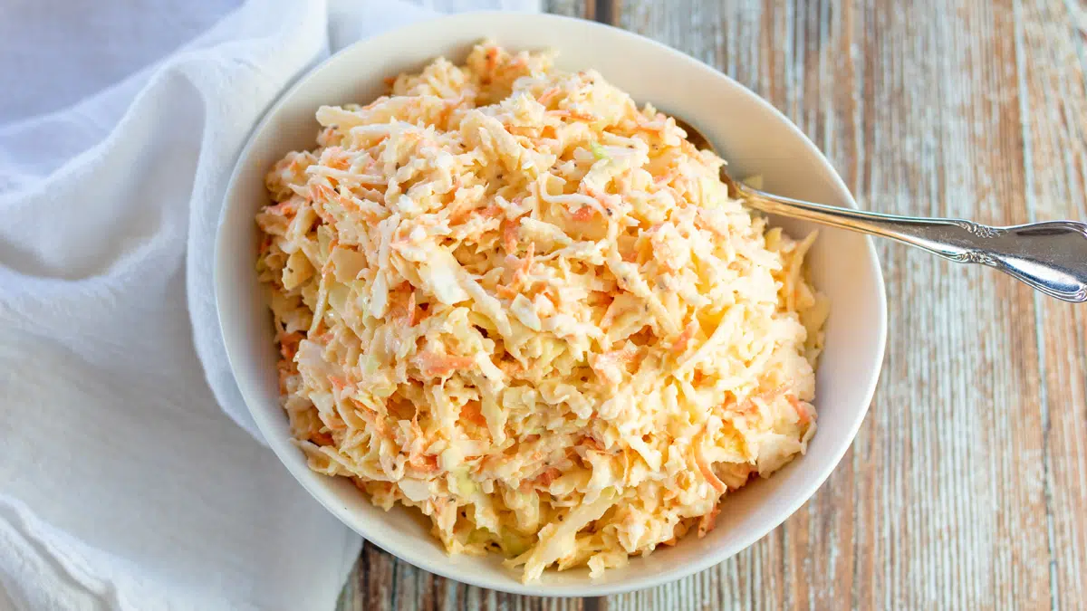 Wide image of Southern coleslaw in a white bowl.