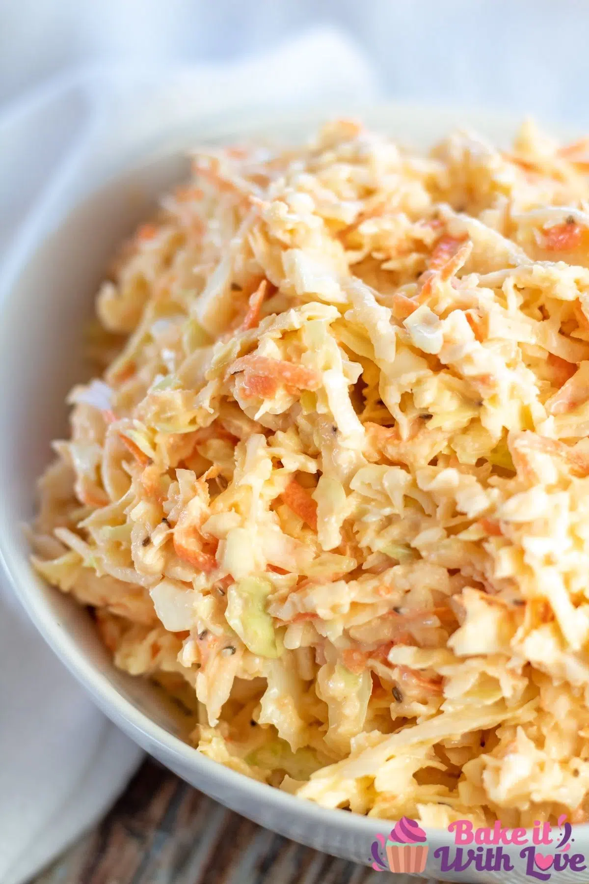 Tall image of Southern coleslaw in a white bowl.