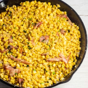 Square image of Southern fried corn in a cast iron skillet.