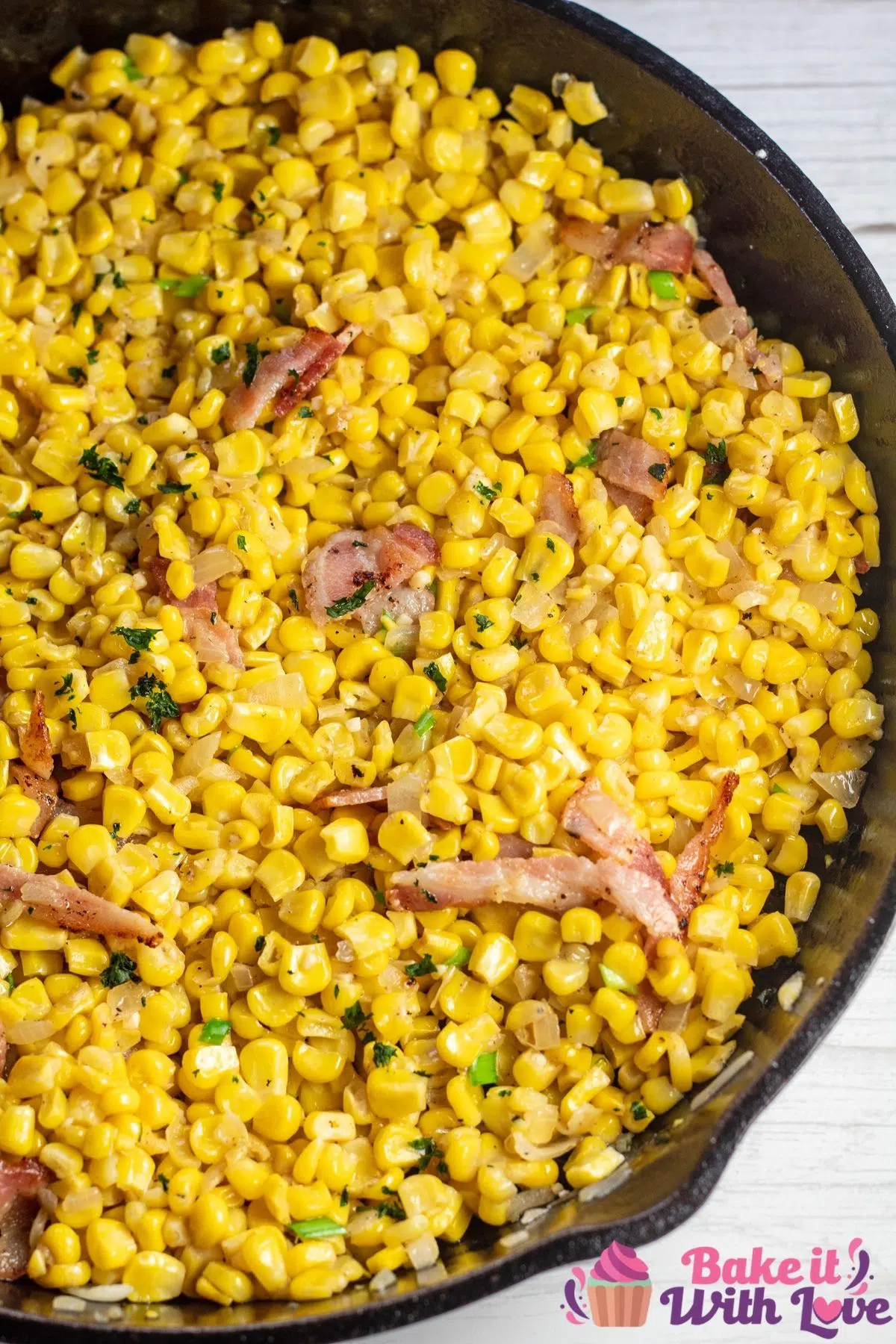Tall image of Southern fried corn in a cast iron skillet.
