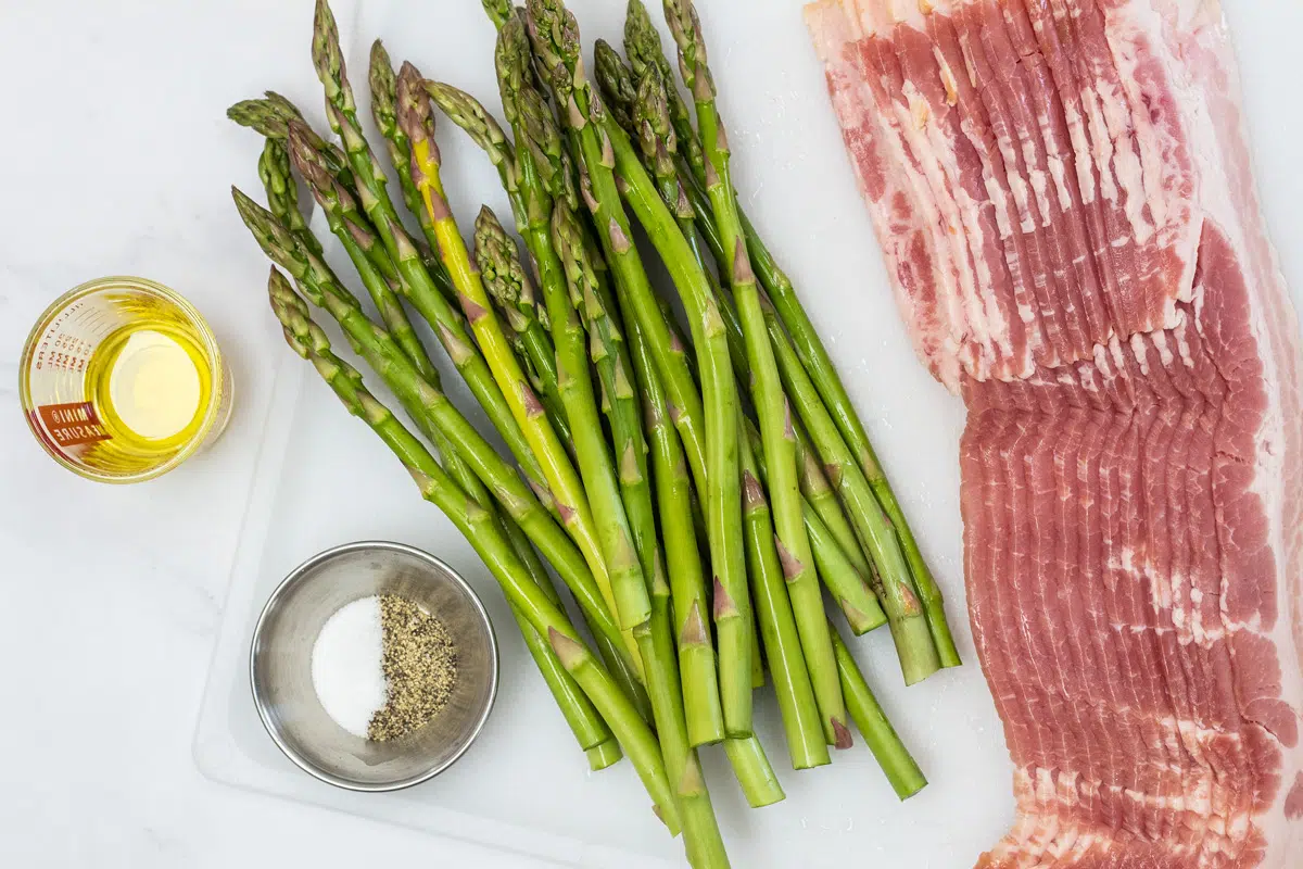 Baked bacon wrapped asparagus ingredients overhead image.
