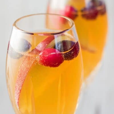 Best mocktail recipes pin with image of mimosa mocktails in champagne glasses and text header.