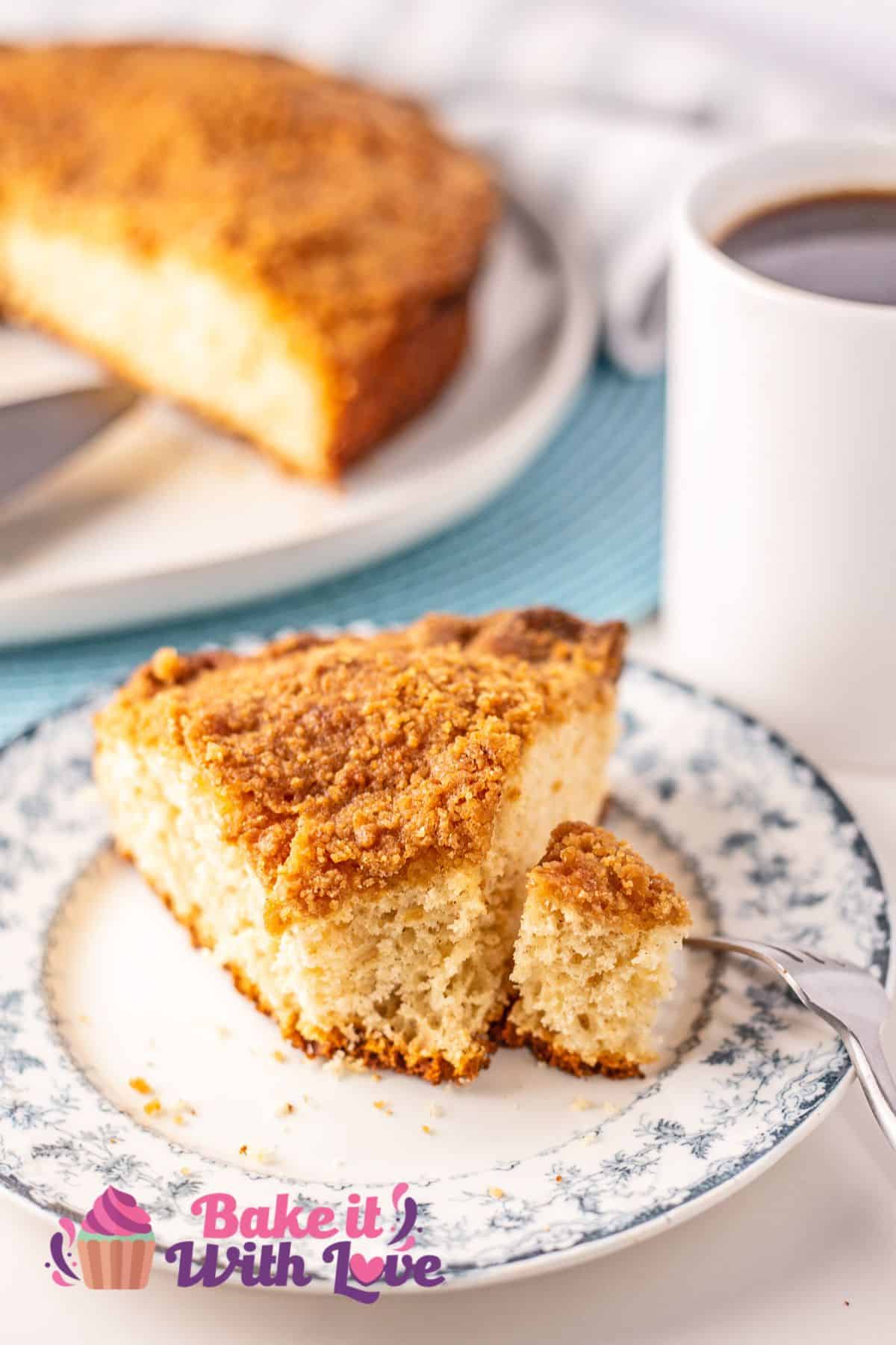 Sliced Bisquick coffee cake served on floral plate with a bite forked to the side.