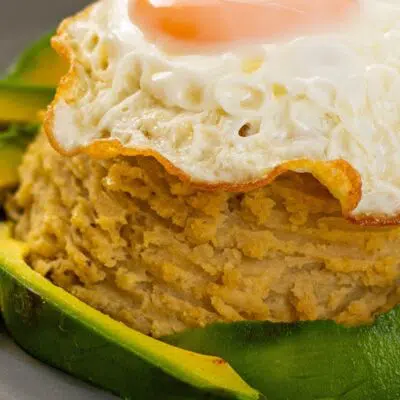 Best mangu recipe pin of mashed green plantains served with fried egg.