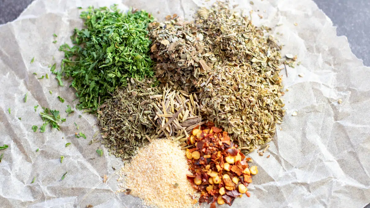 Wide image of homemade Italian seasoning spices.