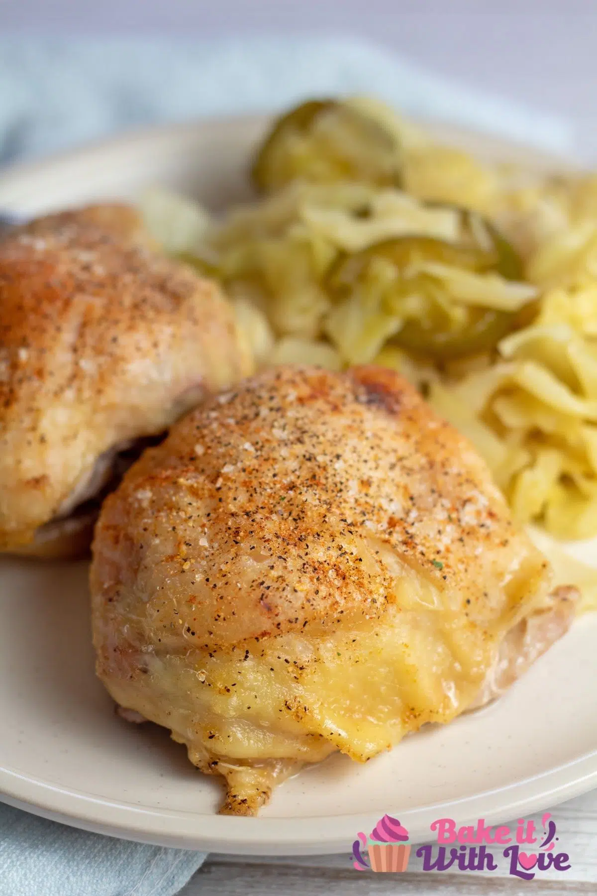 Closeup on the front air fryer chicken thigh with veggies in background.