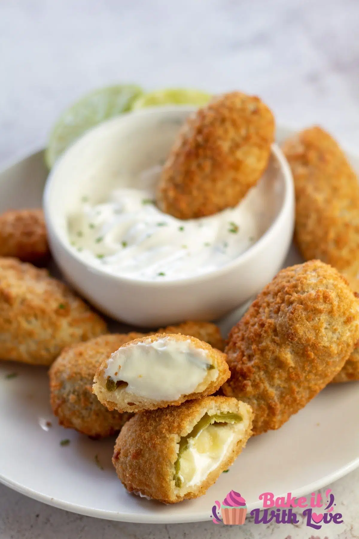 Best golden crispy air fryer frozen jalapeno poppers served with creamy ranch dipping sauce and sliced open on plate.