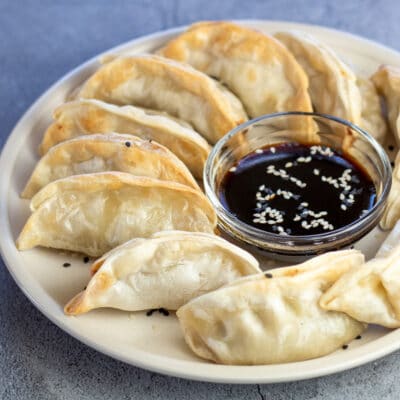 Best air fryer frozen potstickers served on white plate with simple dipping sauce.