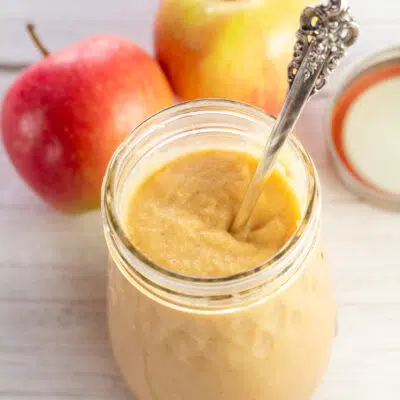 Rich and delicious apple curd in canning jar with spoon.